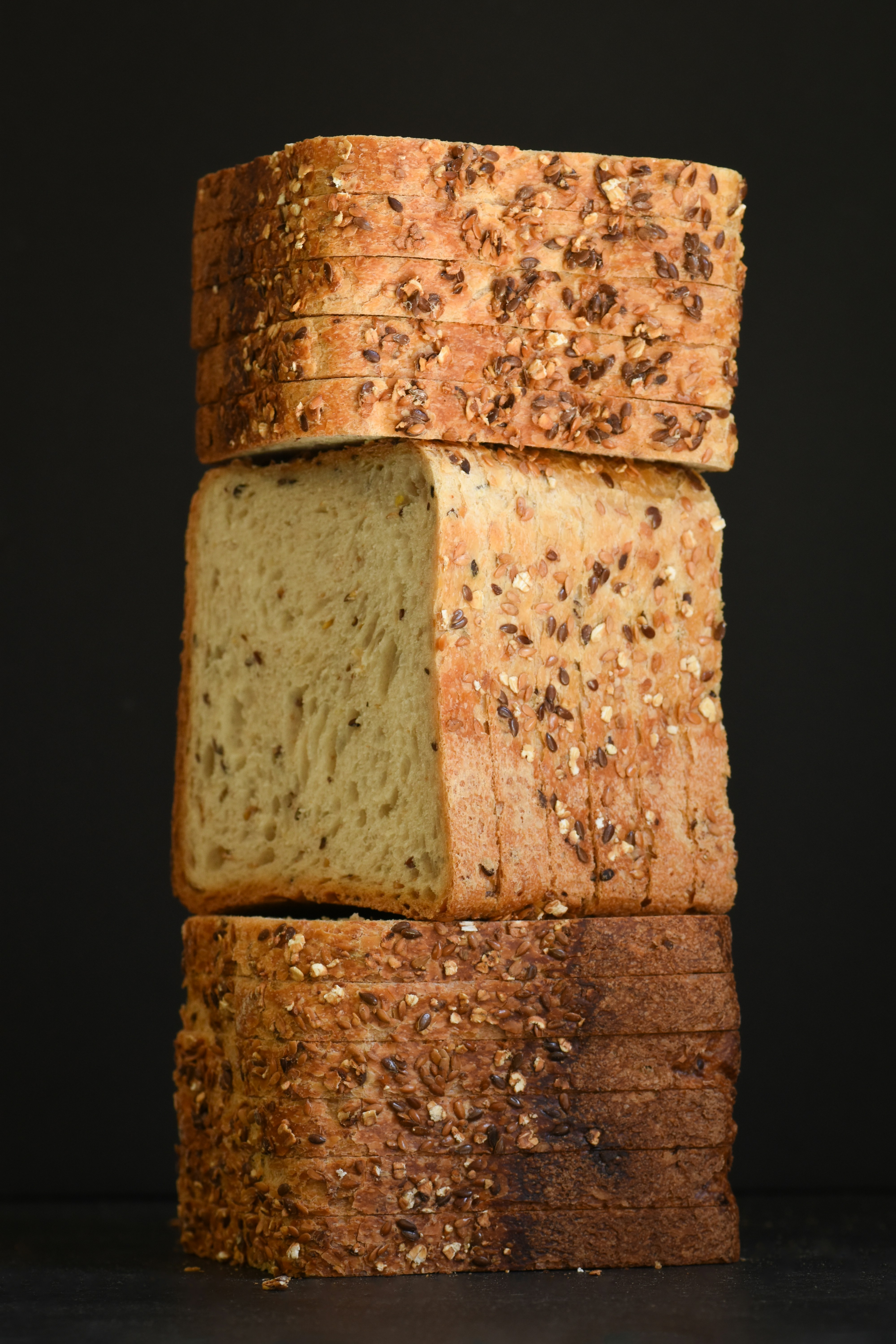 Fresh artisan bread slices on a wooden board